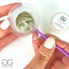 Lash artist using extra strength cream glue remover for lash extensions with micro brush