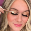 Flat eyeshadow brush applying makeup to model 