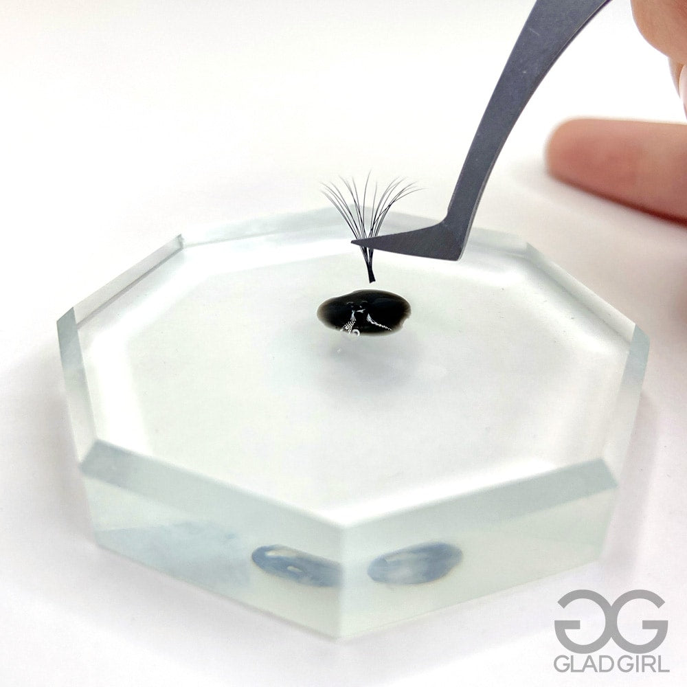 Crystal Glue Palette with drop of eyelash extension adhesive on surface close up