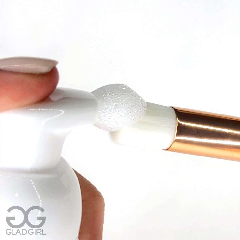 Eyelash cleansing brush applying lash shampoo close up