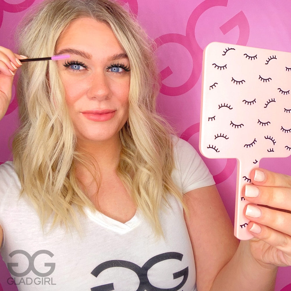 Model using handheld mirror in salon